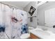 Bathroom with a single vanity, neutral walls, and floral accents on the shower curtain at 5332 Copley Cir, Summerville, SC 29485