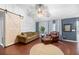 Comfortable living room featuring wood floors, vaulted ceiling, and sliding barn door at 5332 Copley Cir, Summerville, SC 29485