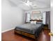 A main bedroom showcases modern decor, wood floors, and natural light from the two windows at 5332 Copley Cir, Summerville, SC 29485