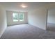 Bright bedroom featuring neutral carpeting, and sun-filled windows offering scenic outdoor views at 538 Pender Woods Dr, Summerville, SC 29486