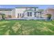Lush backyard showcasing a stone patio, green lawn, and mature trees, creating a serene outdoor space at 612 S Pointe Blvd, Summerville, SC 29483