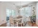 Bright dining room with a rustic wood table, seating for six, sliding glass doors and views to the back patio at 612 S Pointe Blvd, Summerville, SC 29483