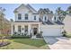 Charming two-story white home with landscaped front yard and inviting front porch at 612 S Pointe Blvd, Summerville, SC 29483
