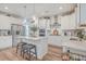Modern kitchen with white cabinetry, stainless steel appliances, central island and hardwood floors at 612 S Pointe Blvd, Summerville, SC 29483