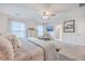 Bright main bedroom featuring a large bed, a ceiling fan, and an ensuite bathroom with modern finishes at 612 S Pointe Blvd, Summerville, SC 29483