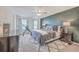 Comfortable main bedroom featuring a large bed, a ceiling fan, stylish decor, accent wall, and lots of natural light at 612 S Pointe Blvd, Summerville, SC 29483