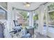 Screened porch with decorative curtains and outdoor seating, perfect for enjoying the weather at 612 S Pointe Blvd, Summerville, SC 29483