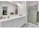 Bright bathroom featuring a double vanity, large mirror, and glass-enclosed shower at 613 Antebellum Ln, Mount Pleasant, SC 29464