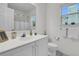 Clean bathroom featuring a white vanity, toilet, and window with natural light at 613 Antebellum Ln, Mount Pleasant, SC 29464