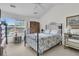 Bright bedroom with a black metal bed frame and antique wood wardrobe at 613 Antebellum Ln, Mount Pleasant, SC 29464