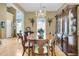 Dining room boasts hardwood floors, chandelier, and lovely cabinet, ideal for Gathering dinners at 613 Antebellum Ln, Mount Pleasant, SC 29464