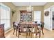 Dining room boasts hardwood floors, chandelier, and lovely cabinet, ideal for Gathering dinners at 613 Antebellum Ln, Mount Pleasant, SC 29464