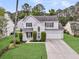 Charming two-story home with a well-manicured lawn, attached garage, and beautiful landscaping at 613 Antebellum Ln, Mount Pleasant, SC 29464