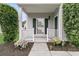 A charming front porch, featuring columns, small garden, and a storm door at 613 Antebellum Ln, Mount Pleasant, SC 29464