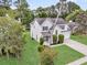 Beautiful two-story house with a well-manicured lawn, mature trees, and a spacious driveway, ideal for families at 613 Antebellum Ln, Mount Pleasant, SC 29464