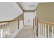 Upstairs hallway with carpet and white wood railing at 613 Antebellum Ln, Mount Pleasant, SC 29464