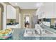 View of the kitchen with stainless steel sink and a view into the dining room at 613 Antebellum Ln, Mount Pleasant, SC 29464