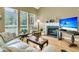 Well-lit living room with fireplace, large windows, and comfortable seating at 613 Antebellum Ln, Mount Pleasant, SC 29464