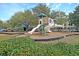 Community playground with slides, climbing structures, and swings set amongst mature trees at 613 Antebellum Ln, Mount Pleasant, SC 29464