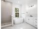 Serene bathroom with a standalone tub, walk-in shower, and modern fixtures at 6518 Beagle Club Rd, Meggett, SC 29449