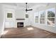 Bright living room with modern ceiling fan, recessed lighting, and decorative fireplace at 6518 Beagle Club Rd, Meggett, SC 29449