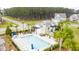 A community pool with lounge chairs and tables offers a relaxing recreation space at 658 Yellow Leaf Ln, Summerville, SC 29486