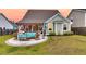 Charming backyard with a pergola, outdoor seating, lush lawn, and well-maintained landscaping at 658 Yellow Leaf Ln, Summerville, SC 29486