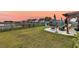 Expansive backyard with a pergola, lounge seating, well-manicured lawn, and serene pond view at 658 Yellow Leaf Ln, Summerville, SC 29486