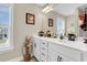 Well-lit bathroom with double windows, ample counter space, and white cabinetry at 658 Yellow Leaf Ln, Summerville, SC 29486