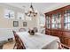 Traditional dining room features hardwood floors, wainscoting, and stylish chandelier at 658 Yellow Leaf Ln, Summerville, SC 29486