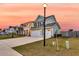 Charming two-story green home with a three-car garage and landscaped front yard at 658 Yellow Leaf Ln, Summerville, SC 29486