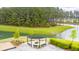 Relaxing firepit area near the lake offers a serene and scenic outdoor gathering space at 658 Yellow Leaf Ln, Summerville, SC 29486
