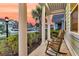 Inviting front porch with rocking chairs and charming columns at 658 Yellow Leaf Ln, Summerville, SC 29486