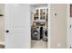 Well-organized laundry room with front loading washer and dryer, cabinet storage, and folding space at 658 Yellow Leaf Ln, Summerville, SC 29486