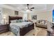 Comfortable main bedroom with a large bed, ceiling fan, and sitting area bathed in natural light at 658 Yellow Leaf Ln, Summerville, SC 29486