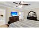 Bedroom featuring a dresser with a TV, ceiling fan, and an adjacent bathroom and doorway to the kitchen at 658 Yellow Leaf Ln, Summerville, SC 29486