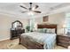 Spacious bedroom boasts a large bed, ceiling fan, and ample natural light from several windows at 658 Yellow Leaf Ln, Summerville, SC 29486
