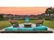 Tranquil patio featuring stylish wicker furniture, lush green lawn, and picturesque neighborhood views at 658 Yellow Leaf Ln, Summerville, SC 29486