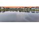 A serene pond reflects a neighborhood row of beautiful and colorful homes at 658 Yellow Leaf Ln, Summerville, SC 29486