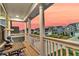 Scenic porch with seating, offering a picturesque view of the neighborhood at sunset at 658 Yellow Leaf Ln, Summerville, SC 29486