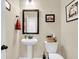 Neutral powder room featuring a pedestal sink and decorative mirror at 658 Yellow Leaf Ln, Summerville, SC 29486