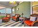 Relaxing screened-in porch with comfortable wicker seating, ceiling fan, and decorative accents at 658 Yellow Leaf Ln, Summerville, SC 29486