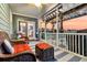 Inviting screened porch with wicker furniture, striped rug, and scenic backyard view at 658 Yellow Leaf Ln, Summerville, SC 29486