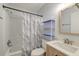 Bathroom with a shower-tub combo, white shower curtain, and light wood vanity at 7955 Timbercreek Ln # 1807, North Charleston, SC 29418