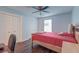 Bedroom with a ceiling fan, wood-look floors, closet, and bed with red linens at 7955 Timbercreek Ln # 1807, North Charleston, SC 29418