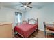 Bedroom featuring wood-look floors, ceiling fan, and bed with red linens at 7955 Timbercreek Ln # 1807, North Charleston, SC 29418