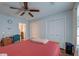 Bedroom with wood-look floors, ceiling fan, closets, and bed with red linens at 7955 Timbercreek Ln # 1807, North Charleston, SC 29418