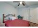 Bedroom featuring wood-look floors, ceiling fan, closet, and bed with red linens at 7955 Timbercreek Ln # 1807, North Charleston, SC 29418