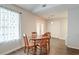 Bright dining area with a wooden table, chairs, and natural light from a large window at 7955 Timbercreek Ln # 1807, North Charleston, SC 29418