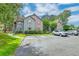 Apartment complex featuring lush landscaping, trees, and convenient parking at 7955 Timbercreek Ln # 1807, North Charleston, SC 29418